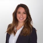 A woman with long brown hair, wearing a white shirt and dark blazer, smiles at the camera against a plain light background, reflecting the welcoming atmosphere of St. Francis Outpatient Therapy in Minnesota. A woman with long brown hair, wearing a white shirt and dark blazer, smiles at the camera against a plain light background, reflecting the welcoming atmosphere of St. Francis Outpatient Therapy in Minnesota.