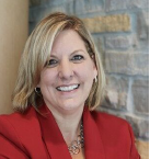 A woman with blonde hair wearing a red blazer is smiling in front of a stone wall background at St. Francis Health Services, where Outpatient Therapy in Minnesota is offered. A woman with blonde hair wearing a red blazer is smiling in front of a stone wall background at St. Francis Health Services, where Outpatient Therapy in Minnesota is offered.