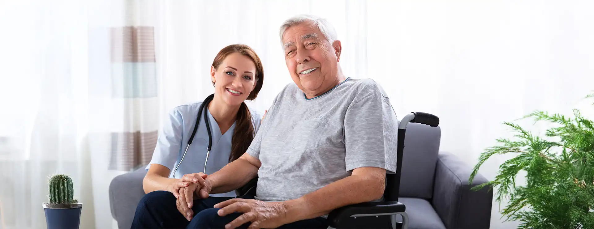 A nurse in scrubs smiles next to an elderly man seated in a wheelchair in a bright, home-like setting with plants, highlighting the compassionate outpatient therapy offered at St. Francis Health Services locations in Minnesota. A nurse in scrubs smiles next to an elderly man seated in a wheelchair in a bright, home-like setting with plants, highlighting the compassionate outpatient therapy offered at St. Francis Health Services locations in Minnesota.